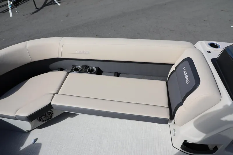 Slide: The Image of 2024 Harris Cruiser 230 boat interior with beige seating and cup holders. - 9
