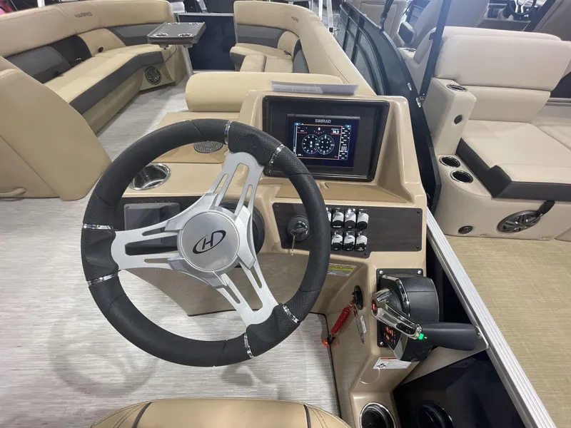 Slide: The Image of 2023 Harris Cruiser 250 boat interior with steering wheel and control panel. - 11
