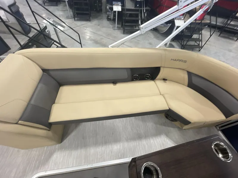 Slide: The Image of 2023 Harris Cruiser 250 boat interior with beige and gray seating. - 12