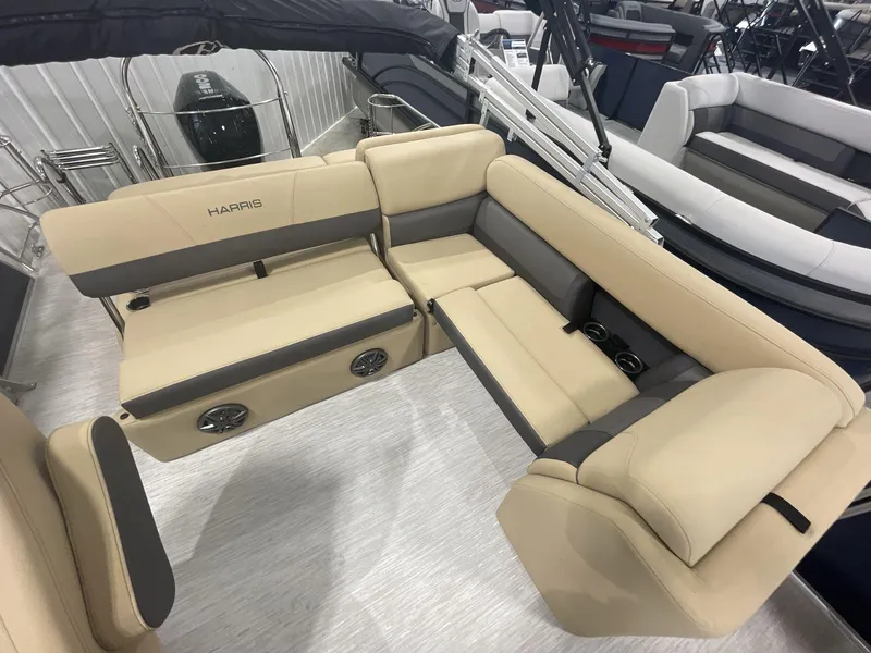 Slide: The Image of 2023 Harris Cruiser 250 boat interior with beige seating and cup holders. - 13