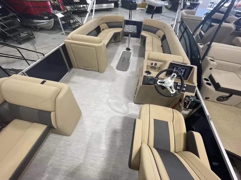 Slide: The Image of 2023 Harris Cruiser 250 pontoon boat interior with beige seating and modern helm. - 7