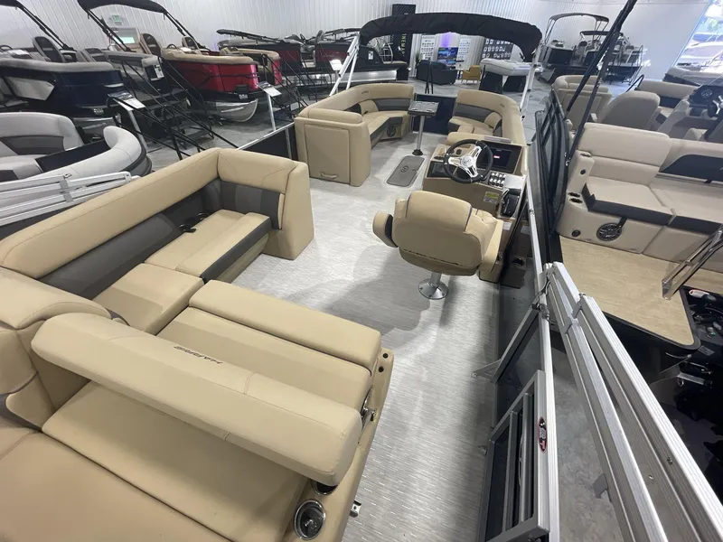 Slide: The Image of 2023 Harris Cruiser 250 pontoon boat interior with beige seating and modern helm. - 8