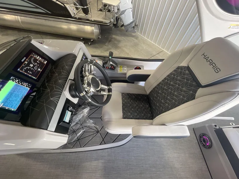 Slide: The Image of 2023 Harris Grand Mariner 250 helm with modern controls and luxurious seating. - 11