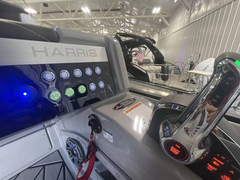 Slide: The Image of Control panel of 2023 Harris Grand Mariner 250 boat with illuminated buttons and throttle. - 13