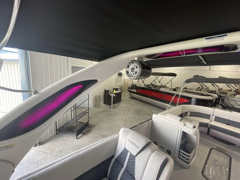 Slide: The Image of 2023 Harris Grand Mariner 250 interior with modern seating and audio system in showroom. - 14