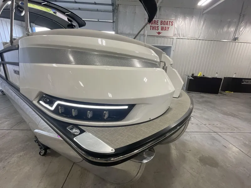 Slide: The Image of 2023 Harris Grand Mariner 250 pontoon boat in a showroom, showcasing sleek design and modern features. - 3