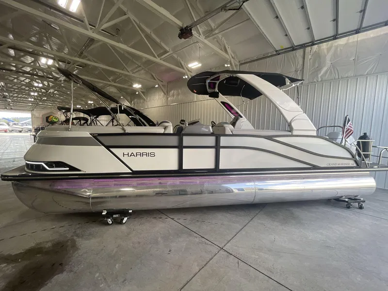Slide: The Image of 2023 Harris Grand Mariner 250 pontoon boat in a showroom setting. - 4