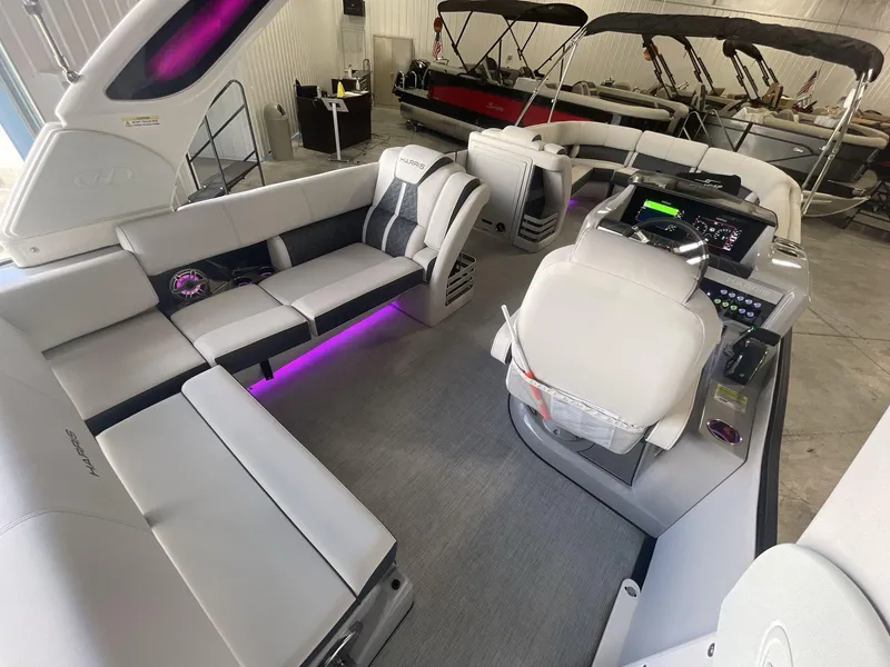 Slide: The Image of 2023 Harris Grand Mariner 250 interior with plush seating and modern dashboard. - 8