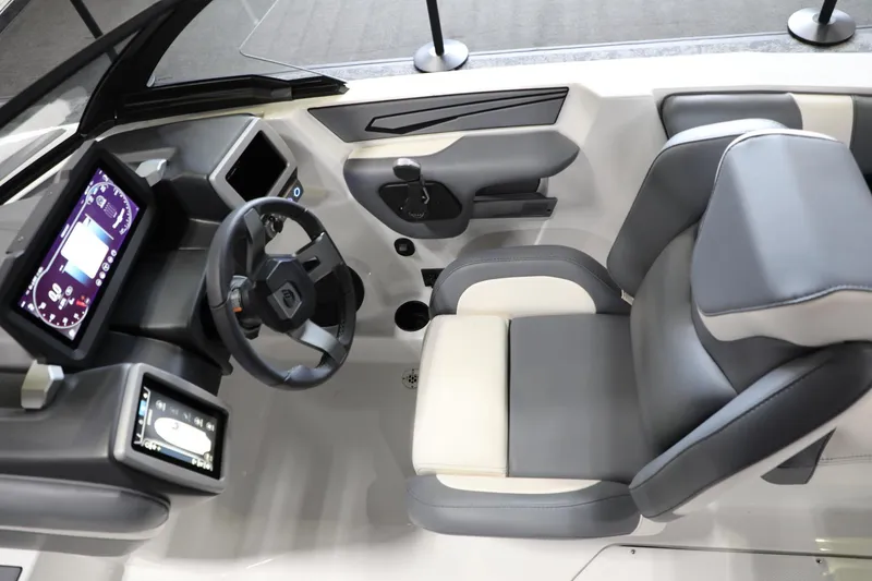 Slide: The Image of 2024 Malibu 21 LX-R boat interior with modern dashboard and comfortable seating. - 11