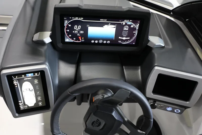 Slide: The Image of Dashboard of 2024 Malibu 21 LX-R boat with digital displays and steering wheel. - 12