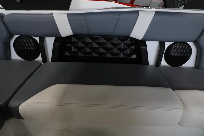 Slide: The Image of 2024 Malibu 21 LX-R boat interior with stylish seating and integrated speakers. - 9