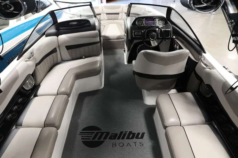 Slide: The Image of Interior of 2014 Malibu 24MXZ boat with luxurious seating and modern dashboard. - 13