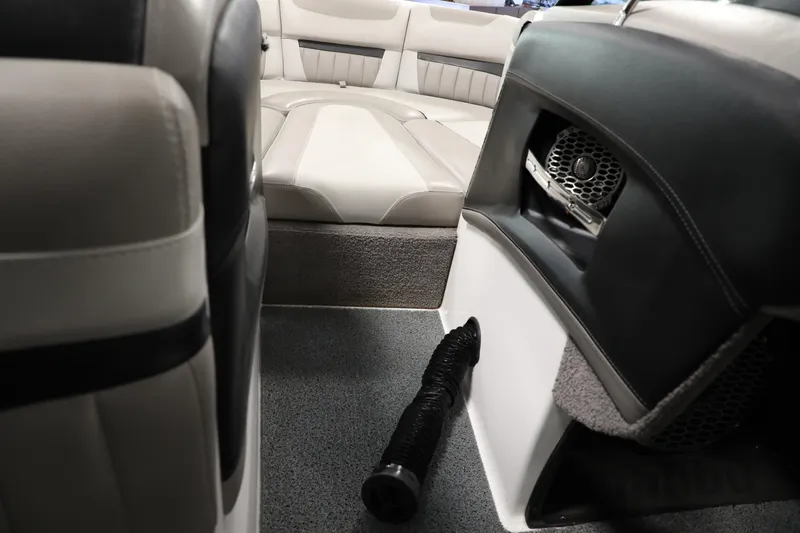 Slide: The Image of 2014 Malibu 24MXZ boat interior with seating and speaker system. - 14