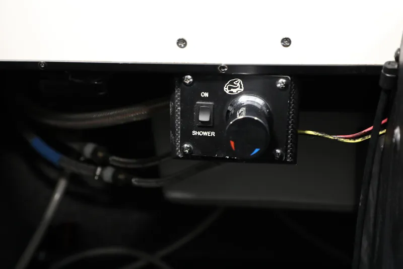 Slide: The Image of 2014 Malibu 24MXZ shower control panel with temperature dial and on/off switch. - 15