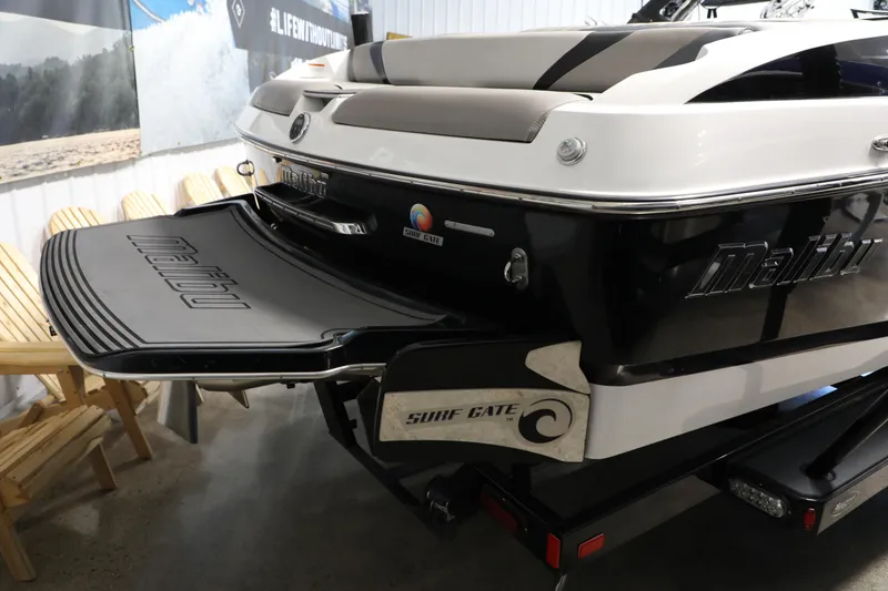 Slide: The Image of 2014 Malibu 24MXZ boat with Surf Gate technology in showroom. - 17