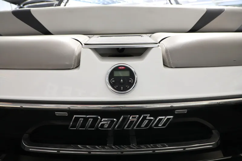 Slide: The Image of 2014 Malibu 24MXZ boat interior with audio controls and logo. - 19