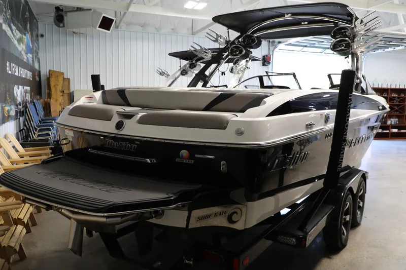 Slide: The Image of 2014 Malibu 24MXZ boat in showroom, rear view, on trailer. - 3