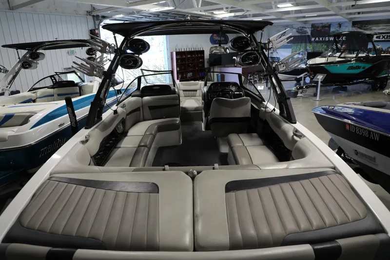 Slide: The Image of 2014 Malibu 24MXZ boat interior with spacious seating and modern design. - 4