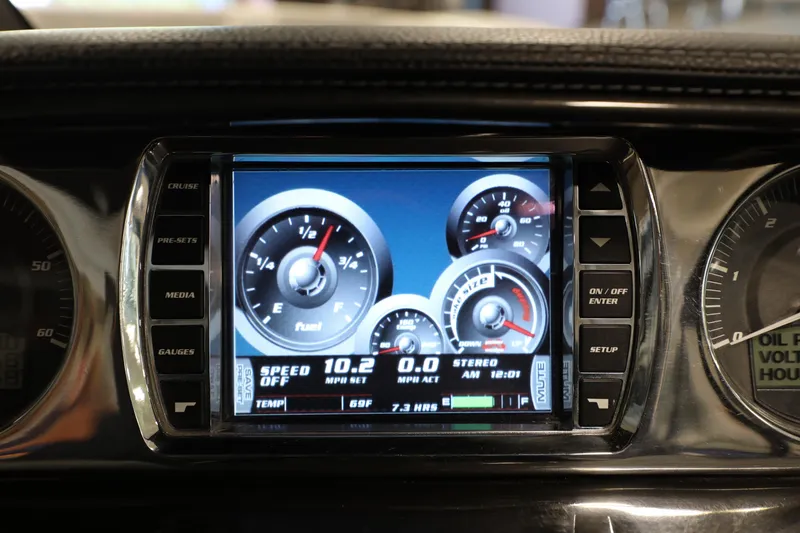 Slide: The Image of Dashboard display of a 2014 Malibu 24MXZ boat showing speed and fuel gauges. - 7