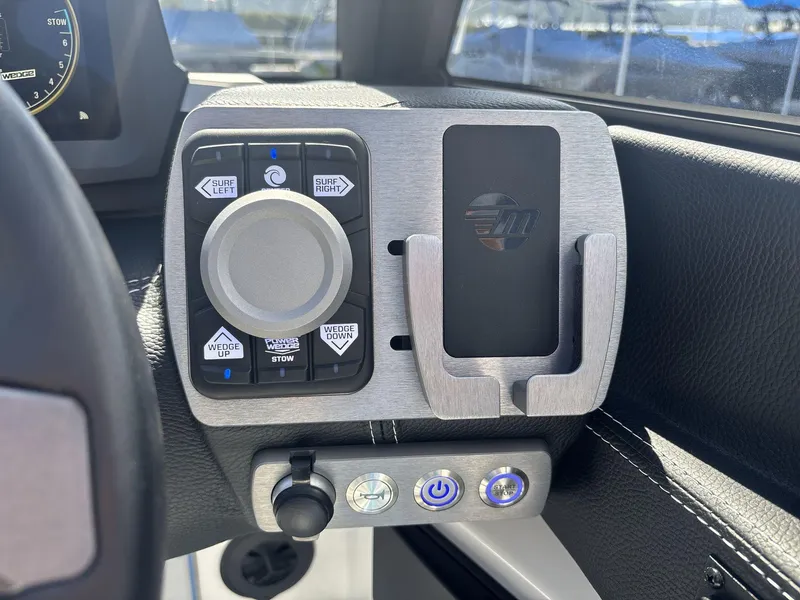Slide: The Image of 2024 Malibu 25LSV boat control panel with surf and wedge adjustment buttons. - 14