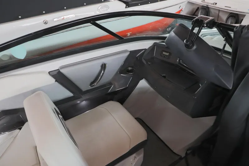 Slide: The Image of Interior of 2018 Monterey 238 SS Surf boat, featuring seating and dashboard. - 10