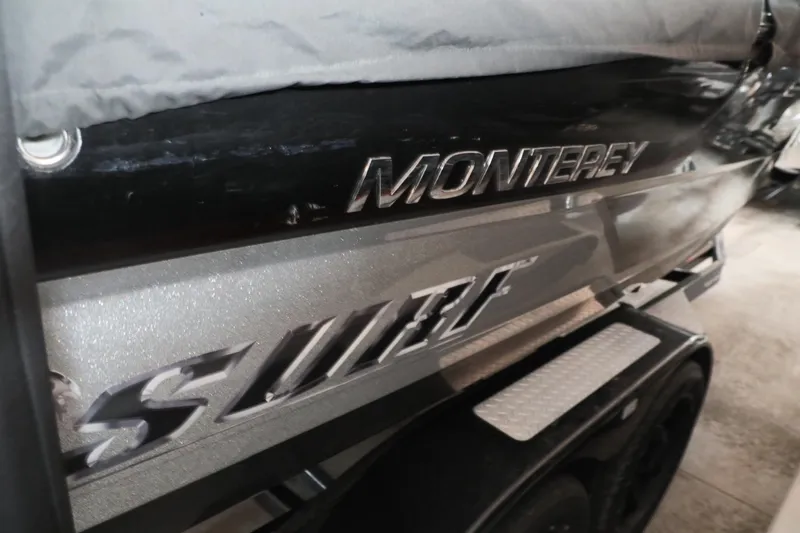 Slide: The Image of 2018 Monterey 238 SS Surf boat, close-up of logo and sleek design. - 13