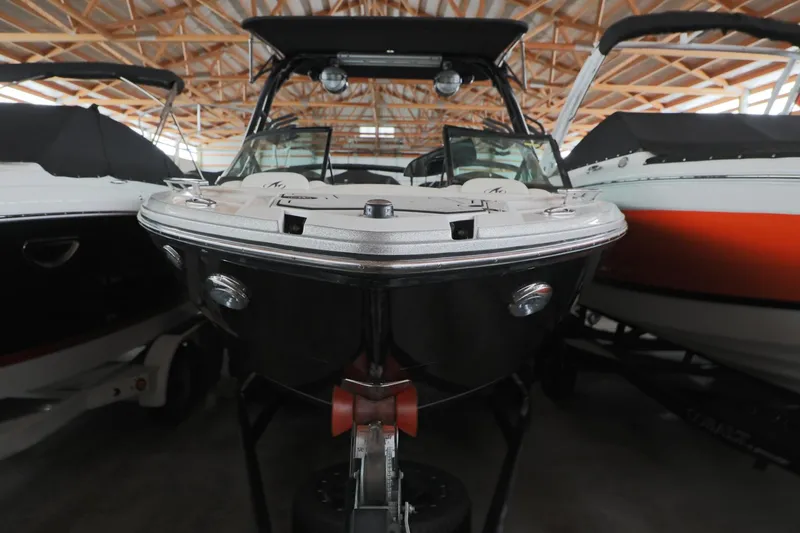 Slide: The Image of 2018 Monterey 238 SS Surf boat in storage, front view, surrounded by other boats. - 3