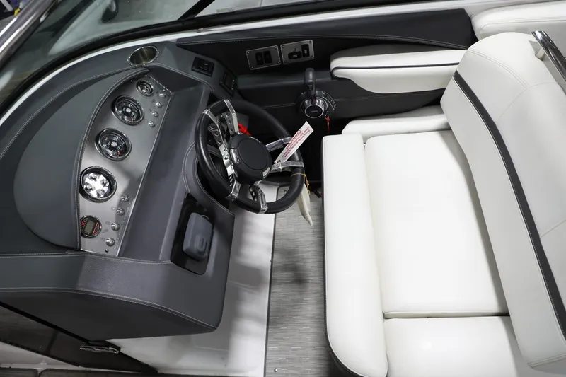 Slide: The Image of 2017 Regal 2800 Bowrider dashboard and steering wheel with white seating. - 14