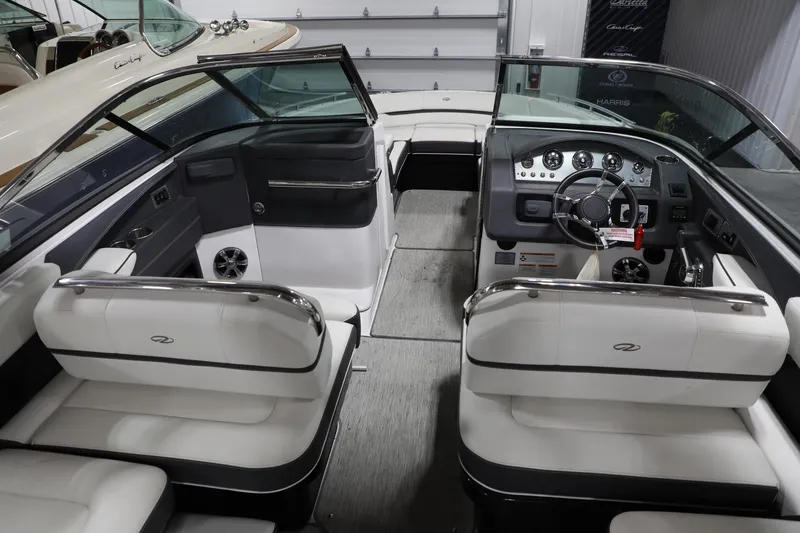 Slide: The Image of Interior of a 2017 Regal 2800 Bowrider boat with white and black seating. - 16