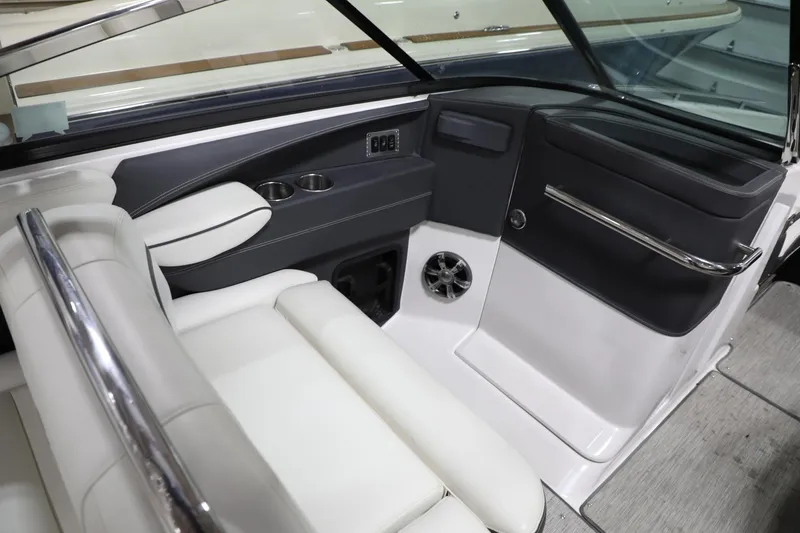 Slide: The Image of Interior of 2017 Regal 2800 Bowrider boat with white seating and modern dashboard. - 17