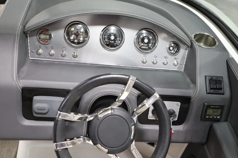 Slide: The Image of Dashboard of a 2017 Regal 2800 Bowrider boat with steering wheel and control gauges. - 3