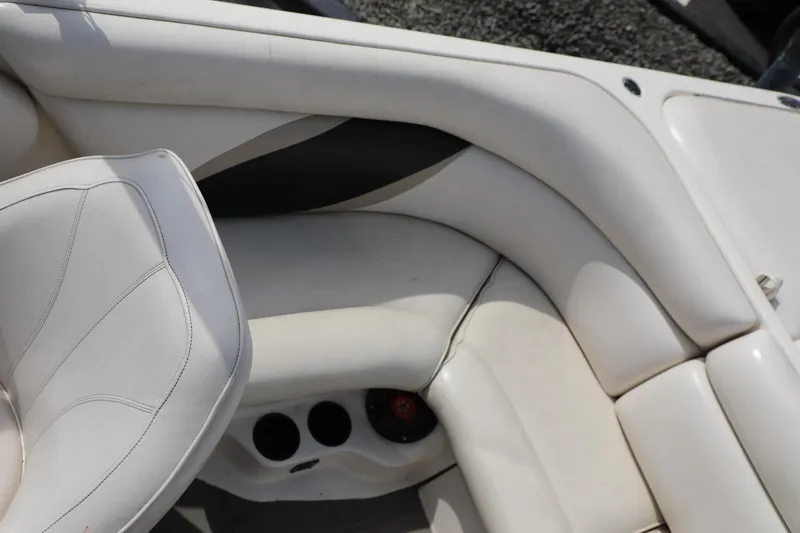 Slide: The Image of 2000 Tigé 2100V boat interior with white leather seating and cup holders. - 12