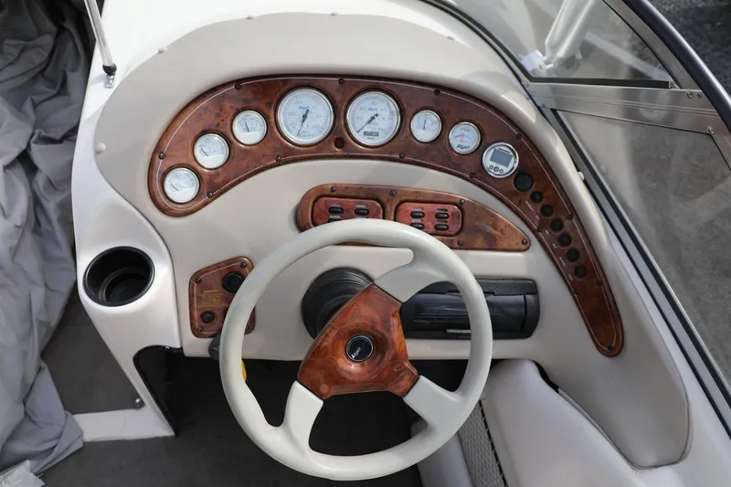 Slide: The Image of Dashboard of a 2000 Tigé 2100V boat with wood accents and gauges. - 15
