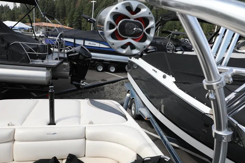 Slide: The Image of 2000 Tigé 2100V boat on trailer, surrounded by other boats in a marina. - 9