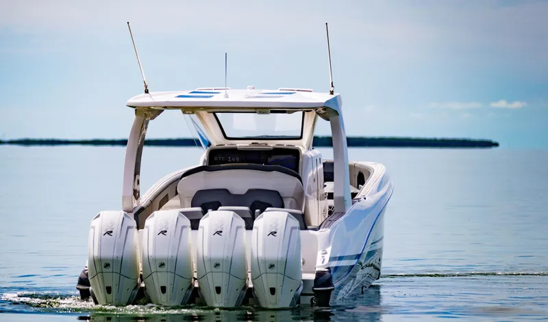 Slide: The Image of 2024 Deep Impact 369 Deep Impact boat with quad outboard engines on calm water. - 10