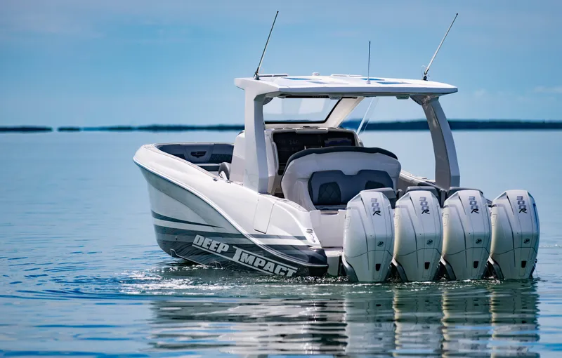 Slide: The Image of 2024 Deep Impact 369 Deep Impact boat with four engines on calm water. - 11