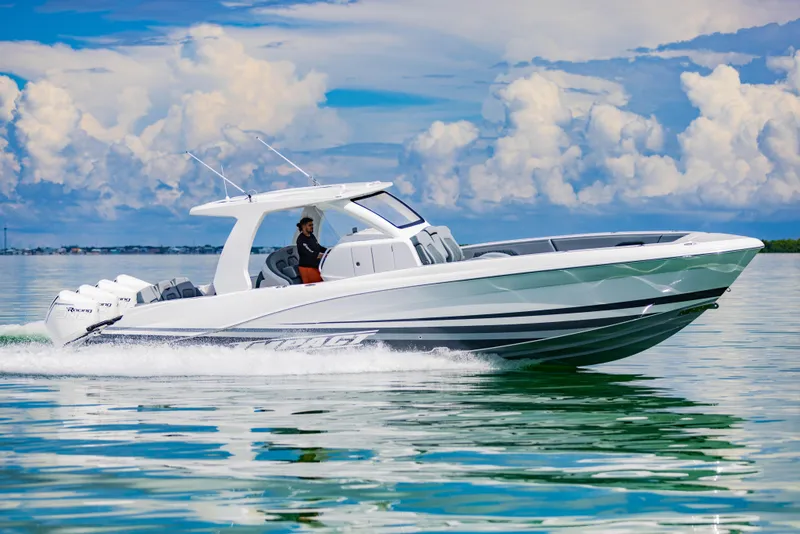 Slide: The Image of 2024 Deep Impact 369 Deep Impact boat cruising on calm waters under a cloudy sky. - 18