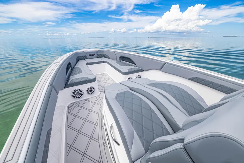 Slide: The Image of 2024 Deep Impact 369 boat interior with luxurious seating on calm water. - 27