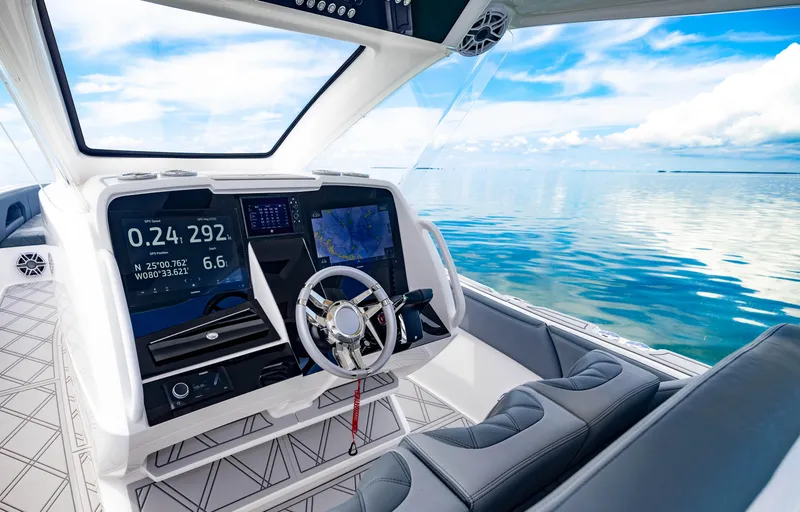 Slide: The Image of 2024 Deep Impact 369 boat cockpit with advanced navigation system on calm waters - 40