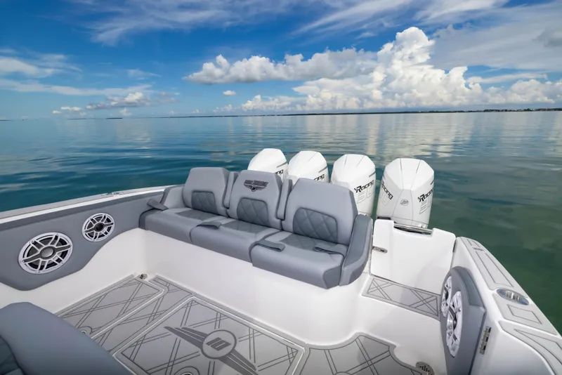 Slide: The Image of 2024 Deep Impact 369 boat with luxurious seating and quad engines on calm water. - 42