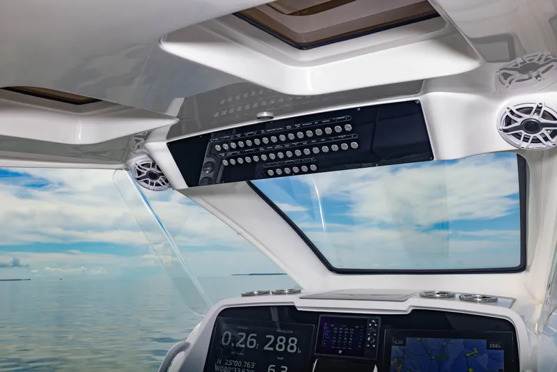 Slide: The Image of 2024 Deep Impact 369 boat cockpit with advanced navigation system and ocean view. - 45