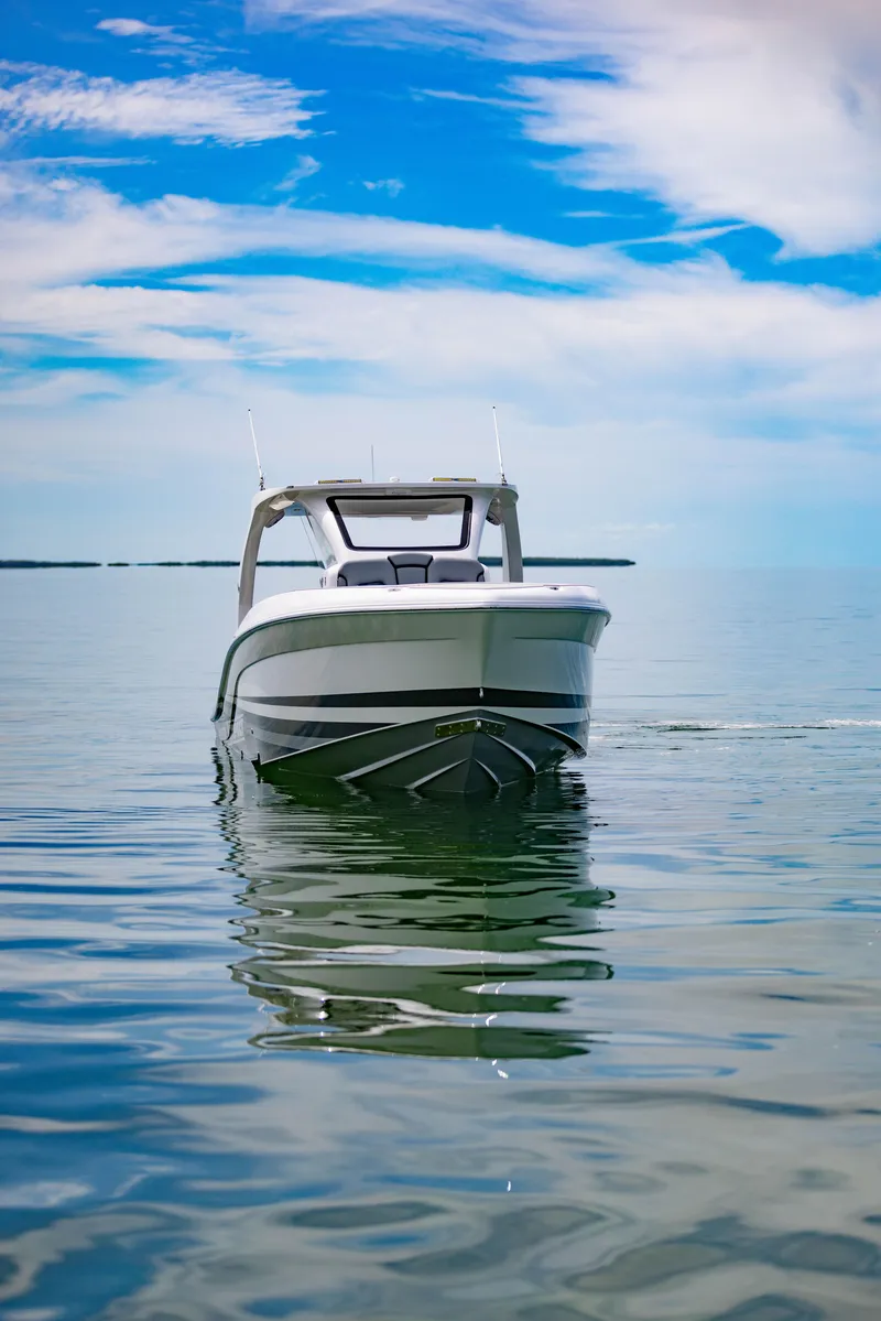 Slide: The Image of 2024 Deep Impact 369 boat on calm water under a blue sky. - 6
