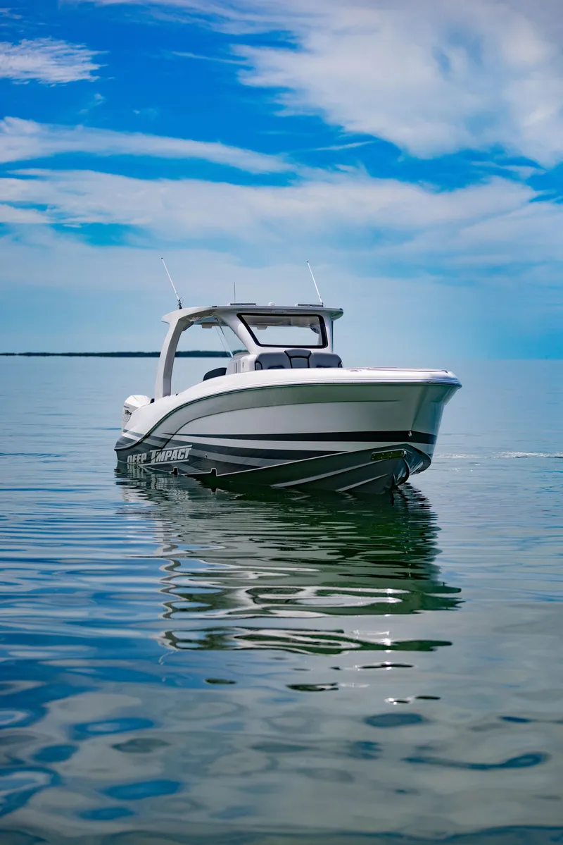 Slide: The Image of 2024 Deep Impact 369 boat on calm water under a blue sky. - 7