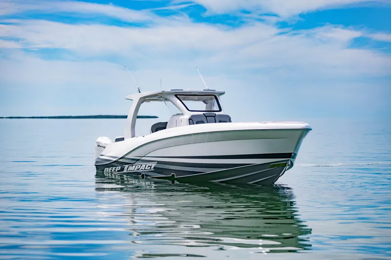 Slide: The Image of 2024 Deep Impact 369 boat on calm water under a blue sky. - 8