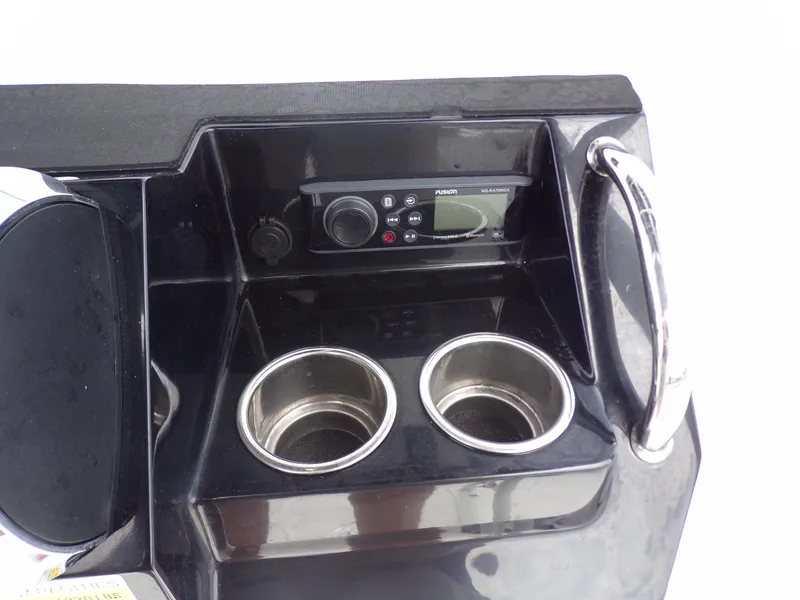 Slide: The Image of 2023 Wellcraft 202 Fisherman console with cup holders and marine radio. - 13