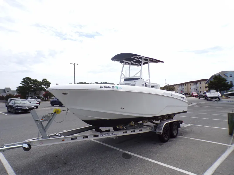 Slide: The Image of 2023 Wellcraft 202 Fisherman boat on a trailer in a parking lot. - 3