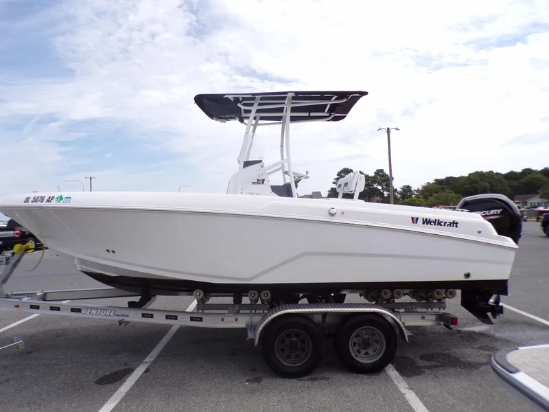 Slide: The Image of 2023 Wellcraft 202 Fisherman boat on a trailer in a parking lot. - 4