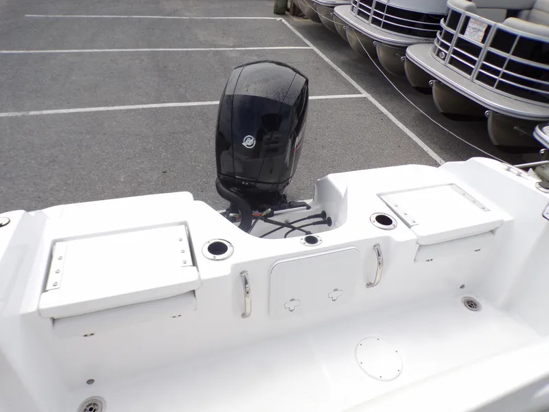 Slide: The Image of 2023 Wellcraft 202 Fisherman boat stern with outboard motor in parking lot. - 7
