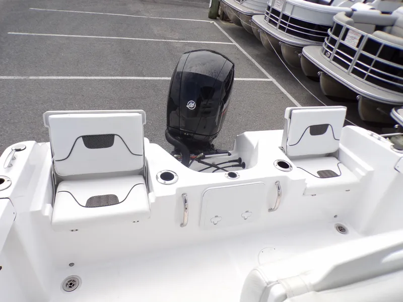 Slide: The Image of 2023 Wellcraft 202 Fisherman boat with outboard motor and seating in a parking lot. - 8