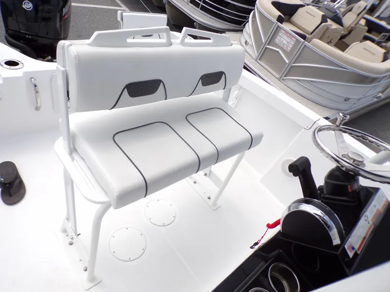 Slide: The Image of 2023 Wellcraft 202 Fisherman boat interior with white seating and steering console. - 9